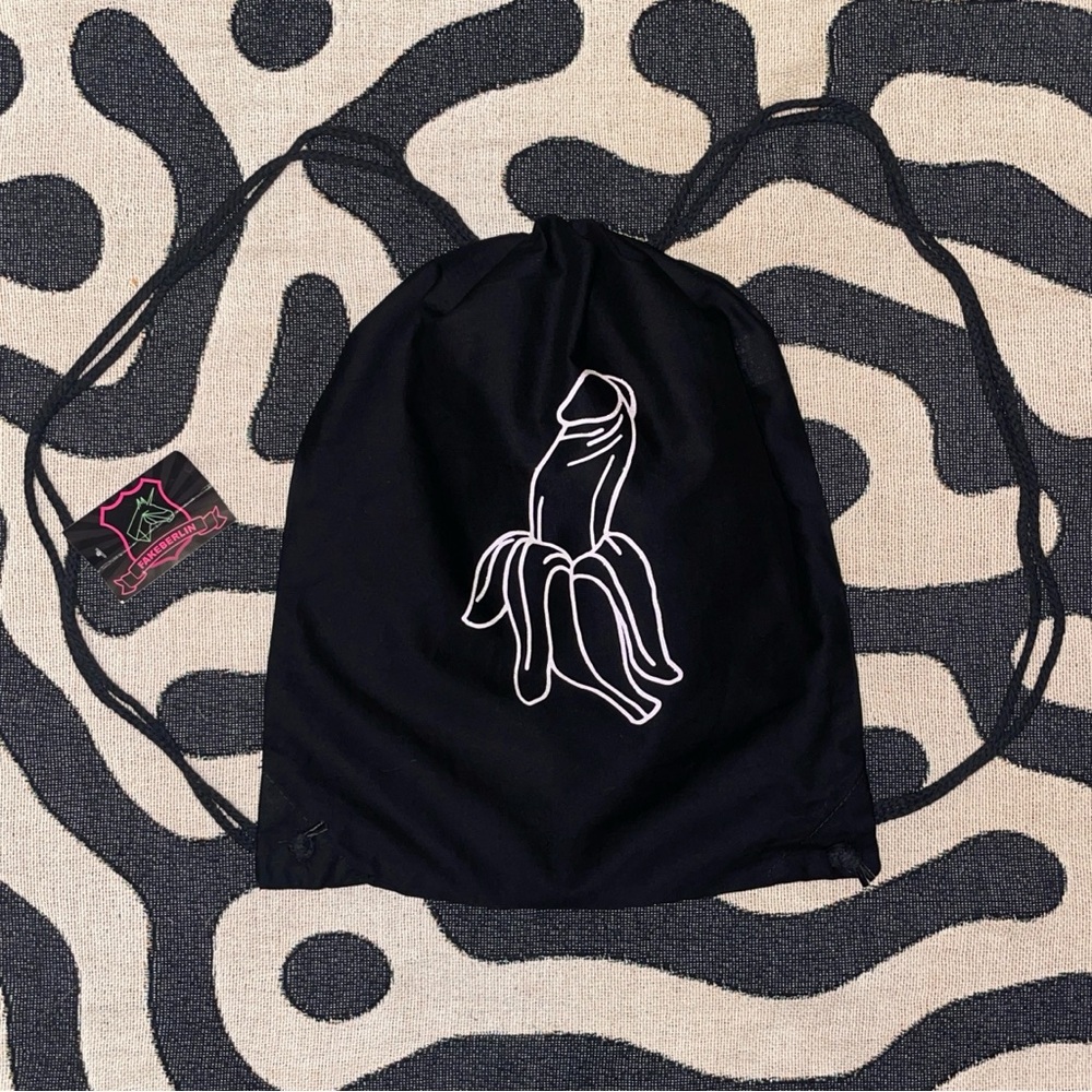 Black string bag with suggestive glitter banana